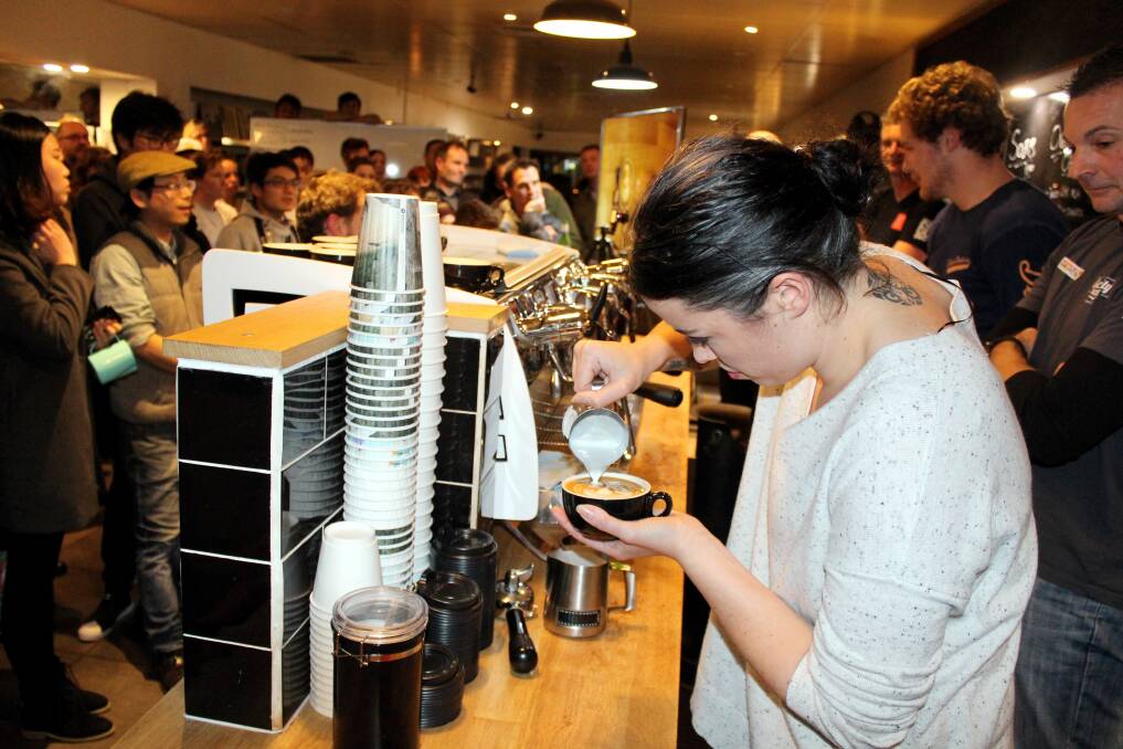 POUR PERFECTION: Mojo Music's Tia Landeg takes out her heat in the Latte Art Smackdown in Launceston on Wednesday night. Twenty-six baristas faced off in the challenge at Mojo Music. Picture: Hamish Geale