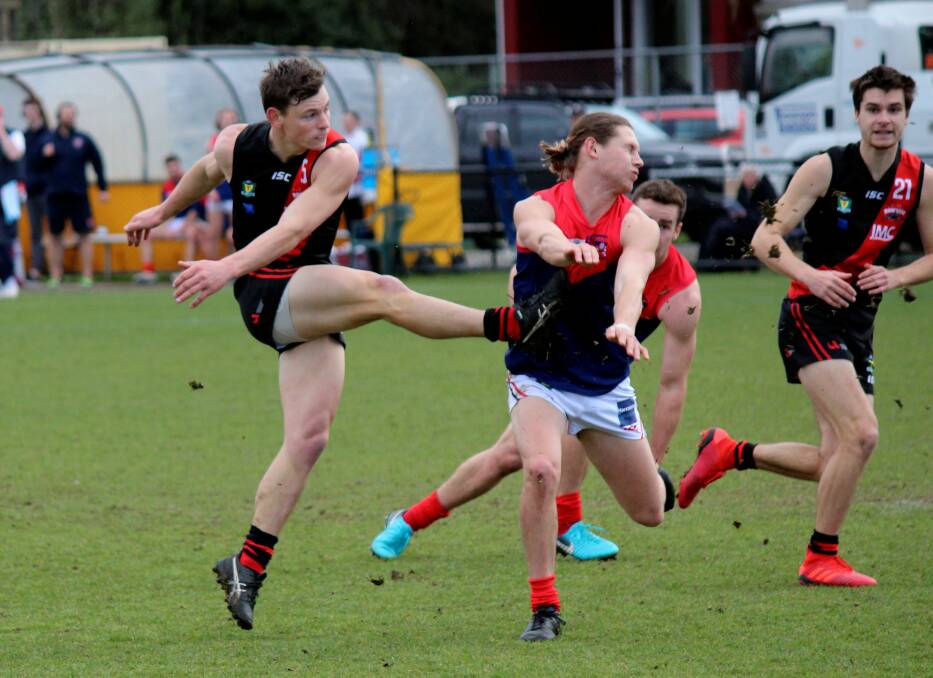 PRESSURE BALL: Jack Avent kicks out of congestion against North Hobart. Pictures: Haimsh Geale 