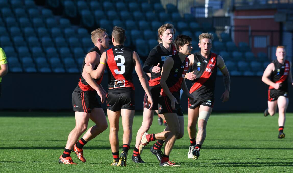 SPIRIT: Bombers come from far and wide after Sherrin Egger's second goal. Egger was one of three Bombers to finish with two. Picture: Paul Scambler