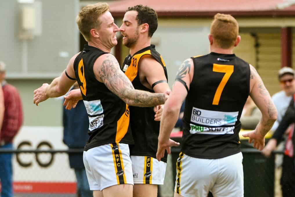 TIGER TIME: Cousens celebrates a goal with Luke Purdon and coach Andrew Cox-Goodyer.