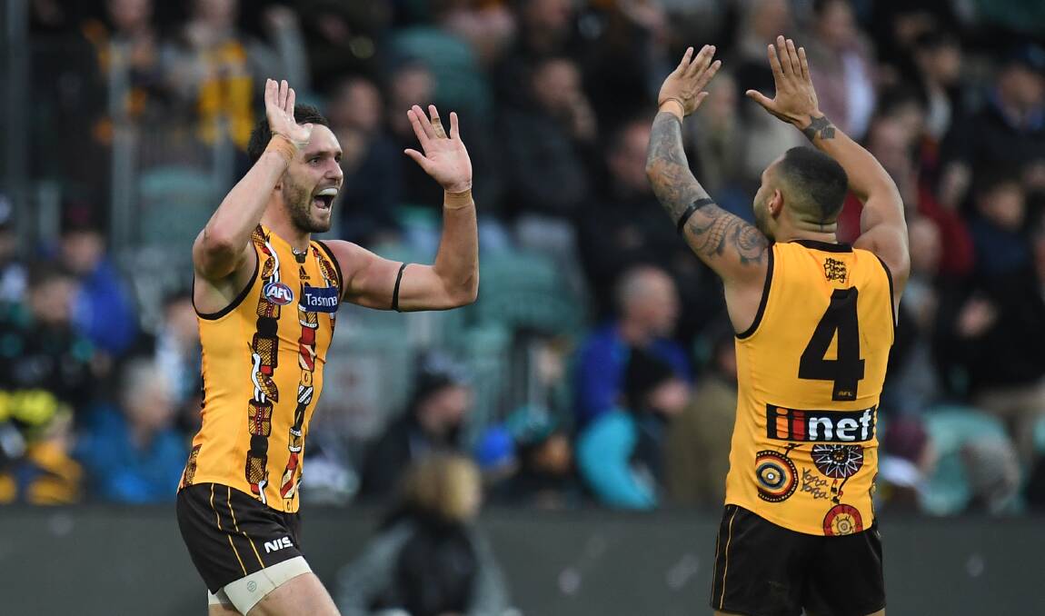 HALF-DOZEN: Hawthorn forward Jack Gunston celebrates the fourth of his six goals with ex-Port speedster Jarman Impey. The Hawks ran out 31-point winners. Pictures: AAP