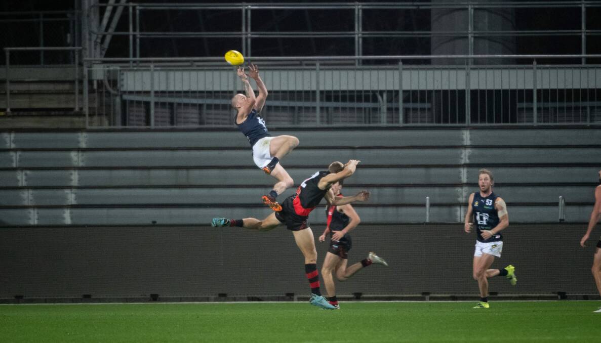 SOARING: Michael Musicka kicked three goals and nearly took mark of the year. 