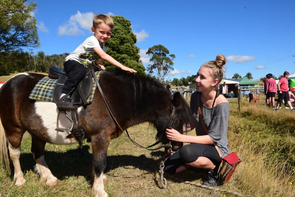 IN THE SADDLE: Swan Point four-year-old Goku James takes a ride on Monty with help from Nikki De Wit. Picture: Paul Scambler.