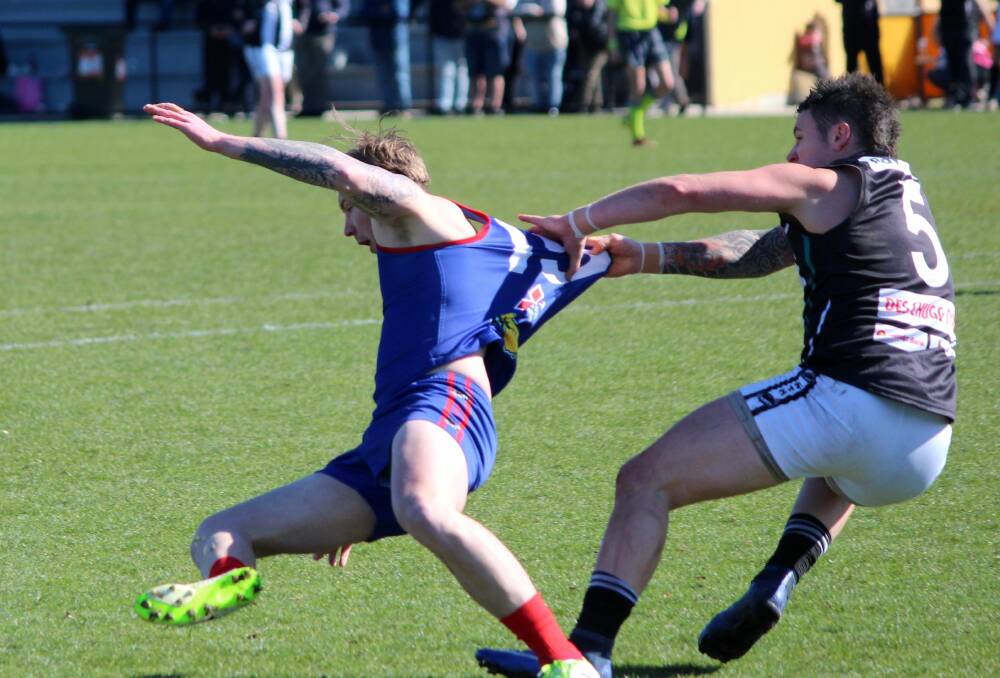 FISTFUL OF JUMPER: Lilydale's Brent Hammersley is dragged off the ball by Perth's Ethan Brown. Picture: Hamish Geale.