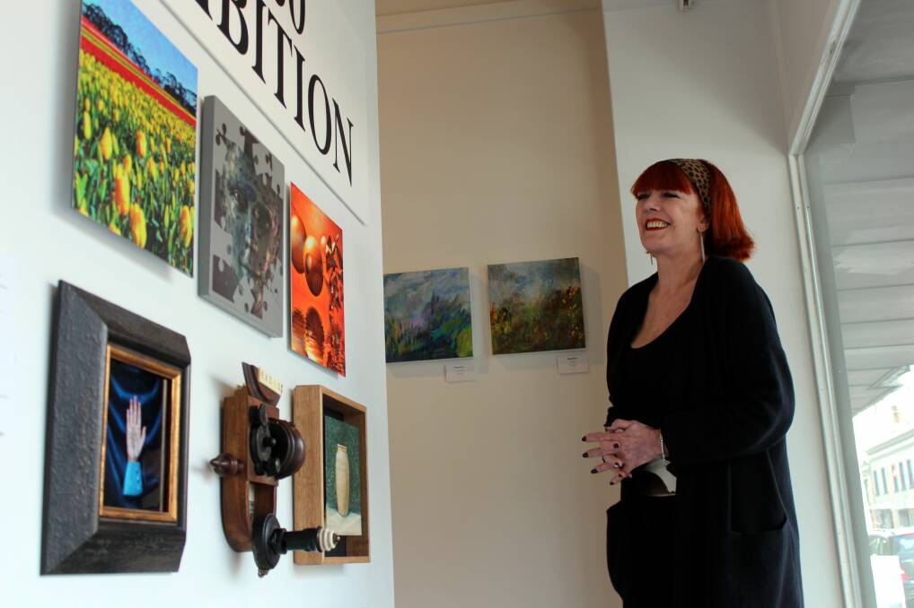 ALL IN A ROW: Gallery Pejean director Margot Baird inspects the gallery's new 30x30 exhibition. Picture: Hamish Geale