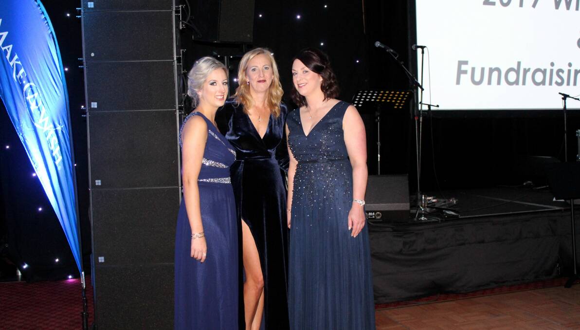 ALL IN BLUE: Make-A-Wish volunteers Suzanne Atkins, Louise Scott and Taihlaura Francis-Denman celebrate another successful winter ball. Picture: Hamish Geale