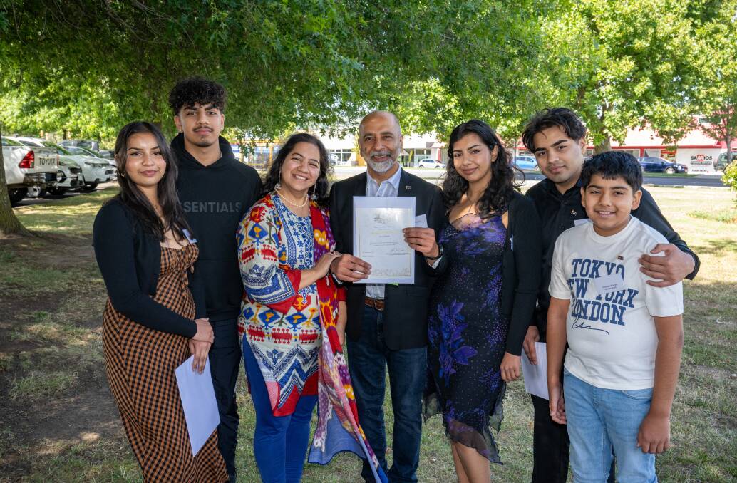 New Australian citizens Imran Anjum and his wife Shahida (centre) and their family Viola, 19, Sahaab, 15, Aroma, 21, Sarmad, 17, and Hussain, 10. Picture by Paul Scambler 