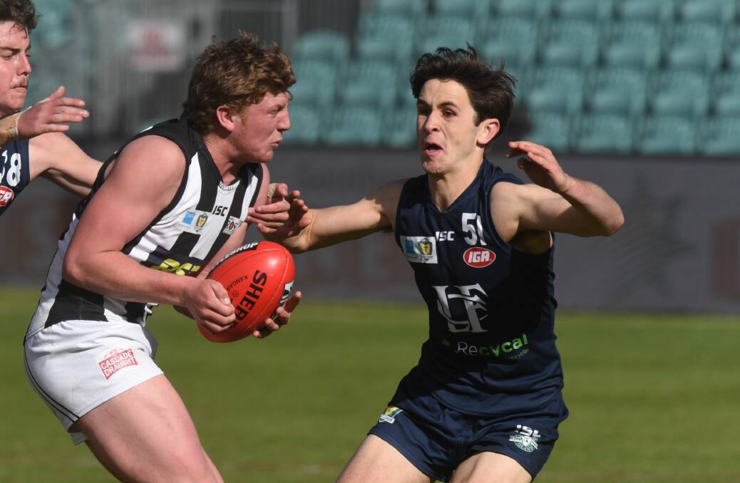 FAMILY TRADITION: Jack Tuthill looks to wrap up a Glenorchy opponent in last year's development league semi-final. Picture: Paul Scambler 