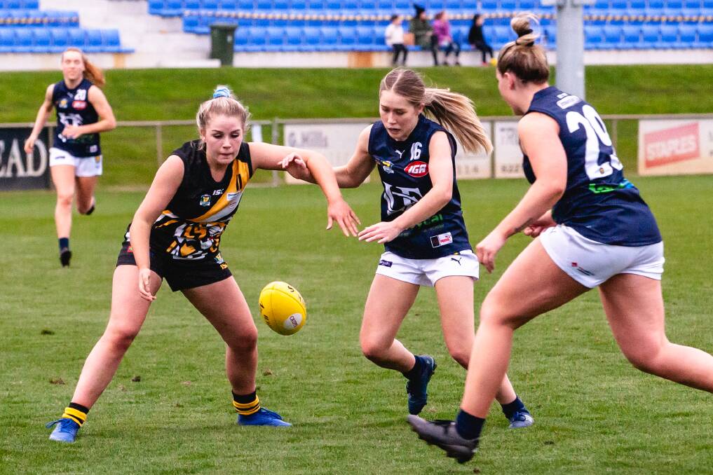 ANYONE'S BALL: Tiger Brooke Phillips and Launceston rival Sian Beeton fight for possession at the Twin Ovals on Saturday. Picture: Solstice Digital