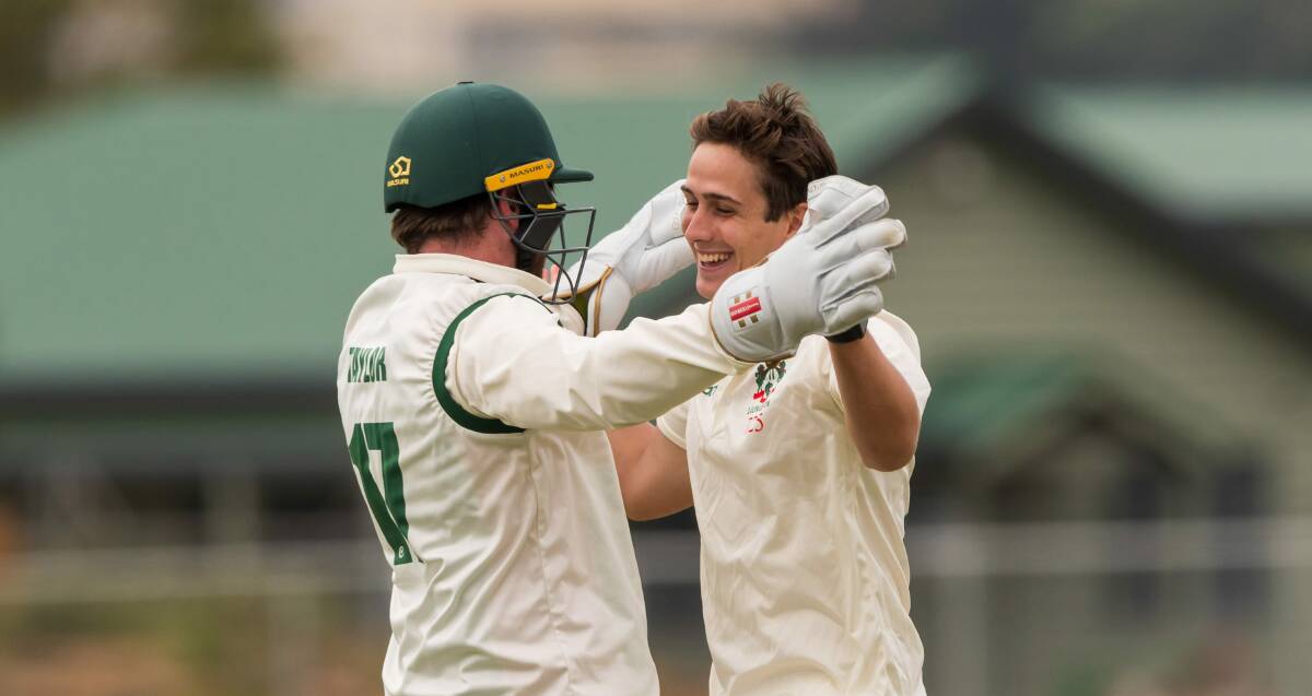 TIRELESS: Launceston spinner James Curran celebrates a wicket with Alistair Taylor. Picture: Phillip Biggs