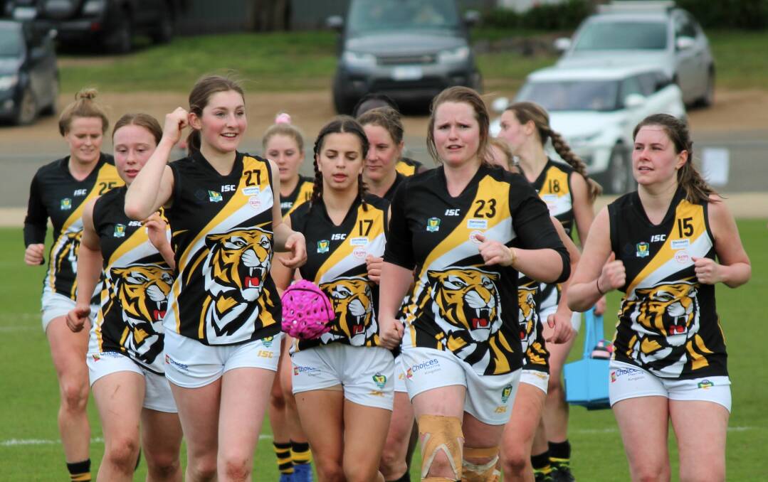 STEPPING BACK: Tigers quartet Phoebe Parsons, Sacha Rival-Quinn, Mikayla Absolom and Madison Barr lead their team off the ground earlier this year. Picture: Hamish Geale 