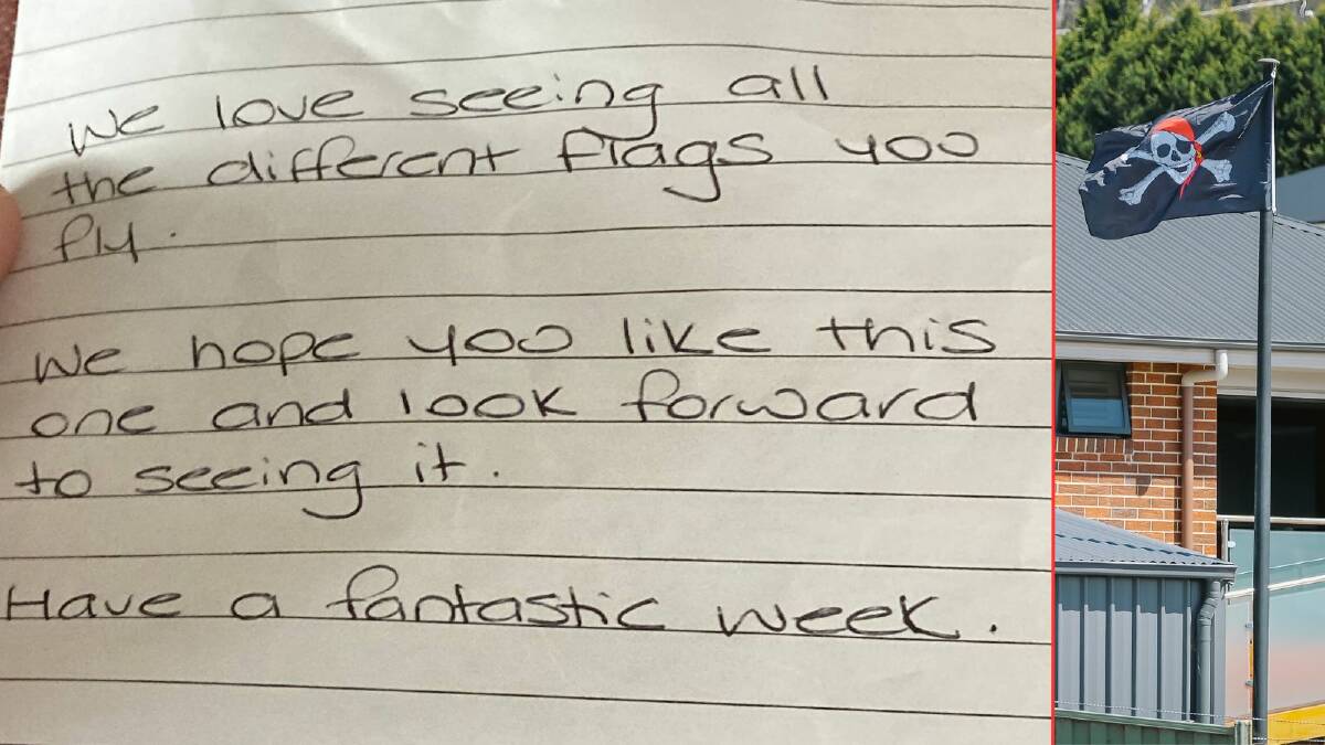 The note and flag that was dropped in their letterbox. Picture by Craig George 