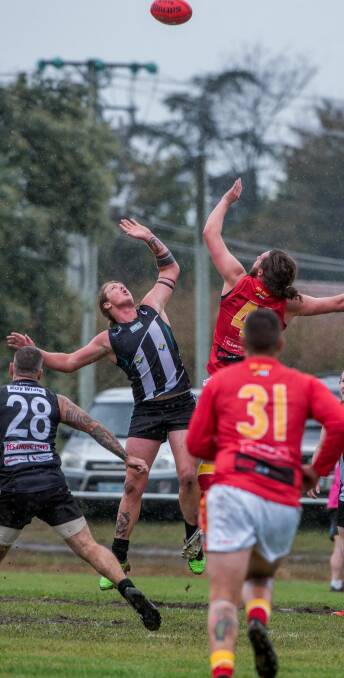 TALL TIMBER: Magpie Nathan Worker flying high in the ruck. Pictures: Neil Richardson