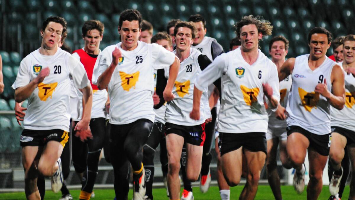 AMONG STARS: A young Braden van Buuren (#25) trains with a host of gun footballers including Josh McGuinness, Toby Nankervis, Zac Webster and Jay Foon.