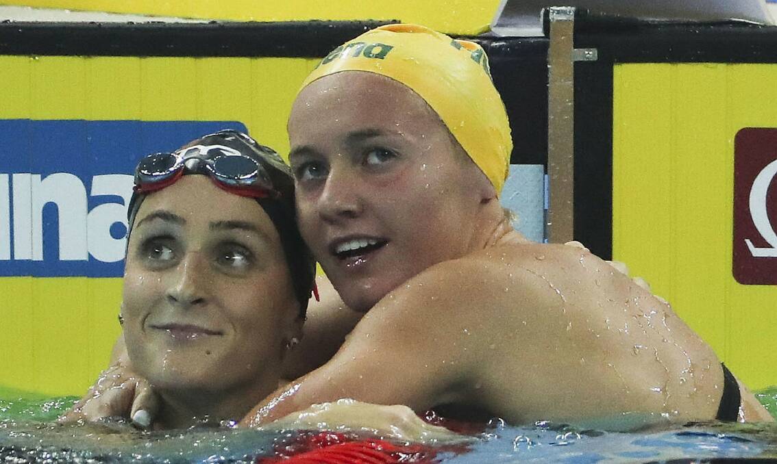 THERE IT IS: Tasmanian swimming sensation Ariarne Titmus hugs American Leah Smith after breaking the women's 400m freestyle world record with a time of 3:53.92. Picture: AP