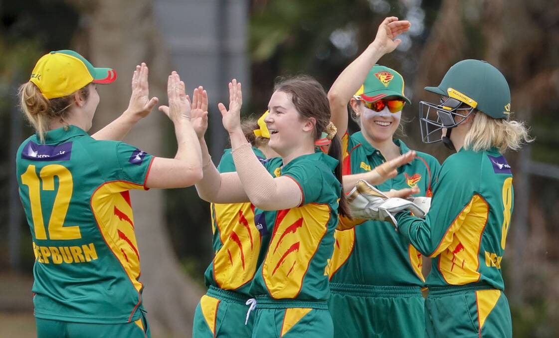 HIGH TEN: Former Trevallyn Primary and Riverside High student Courtney Webb celebrates a wicket with skipper Brooke Hepburn. Picture: AAP