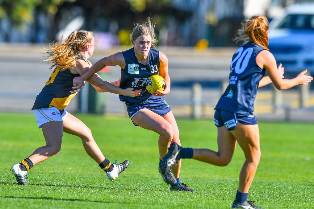 ALLIES ALL YEAR ROUND: Camilla Taylor looks to get a handball off to Launceston teammate Mia King against Tigers earlier this year. Picture: Scott Gelston