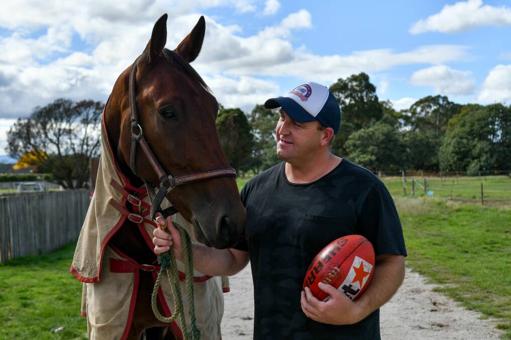 MATES: Adrian Collins spends some time with Gotta Good Reason at Carrick. Picture: Scott Gelston