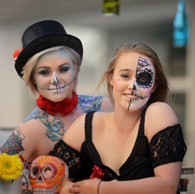DAY OF THE DEAD: Jess Wyllie and Chelsea Mawer get into the spirit of Holy Guacamole's Day of the Dead celebrations in the Quadrant Mall. Picture: Phillip Biggs 
