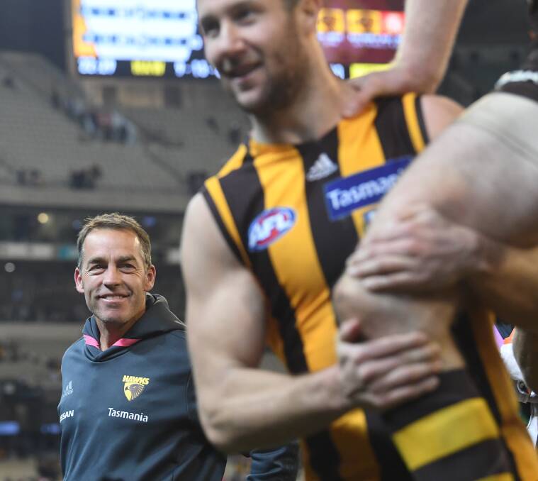 HARSH REPUTATION: Alastair Clarkson watches on as Ben McEvoy and Luke Breust are chaired off after the Hawks' win over Collingwood. Picture: AAP