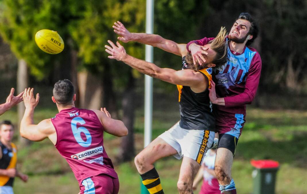 DON'T LOOK NOW: Hillwood ruckamn Jye Balym spoils Longford tall Sam Graham. The Country Tigers won a nail-biter to nab an unlikely spot in finals. Picture: Neil Richardson