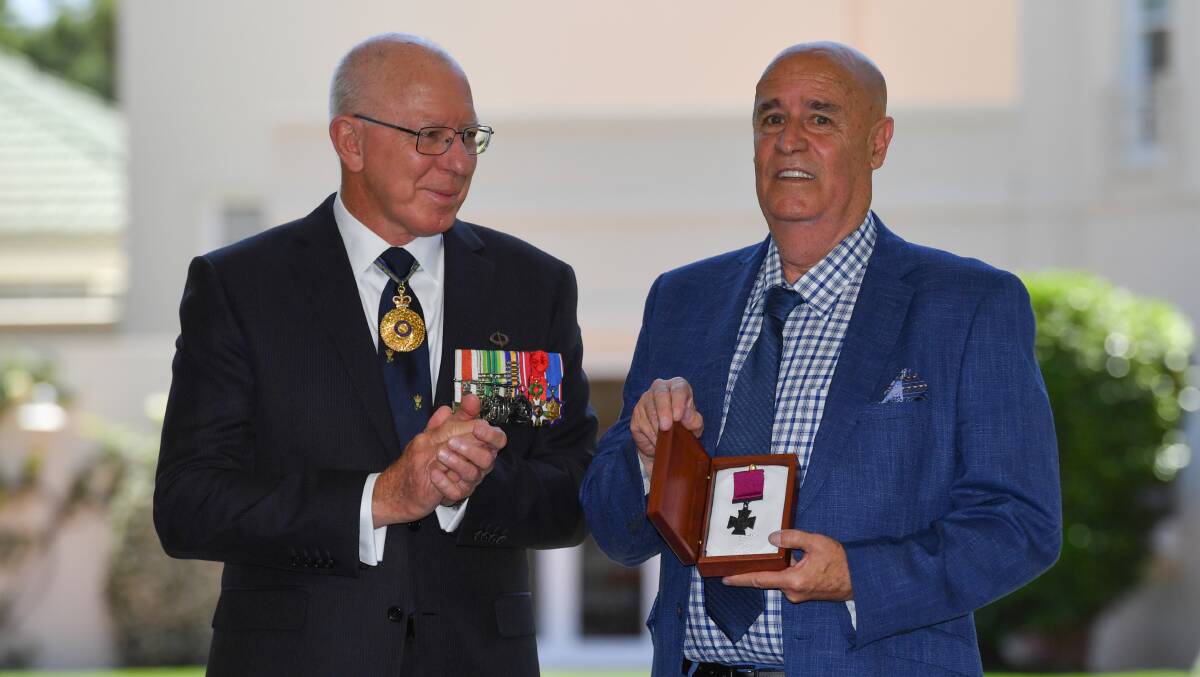 Governor-General David Hurley presents the Victoria Cross to Garry Ivory, nephew of Ordinary Seaman Edward Teddy Sheean in Canberra. Picture: AAP 
