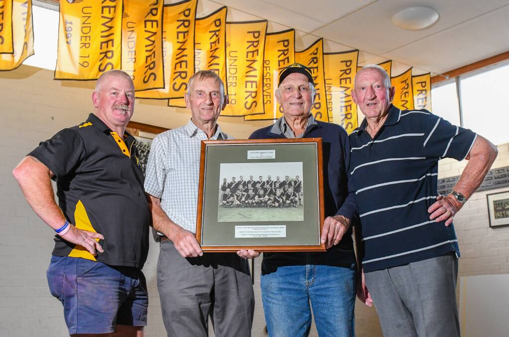 REUNION: Longford president David Blair with 1957 state premiership players Don Brooks, Len Pitt and Jack Barnes holding a team photo. Picture: Paul Schwamm