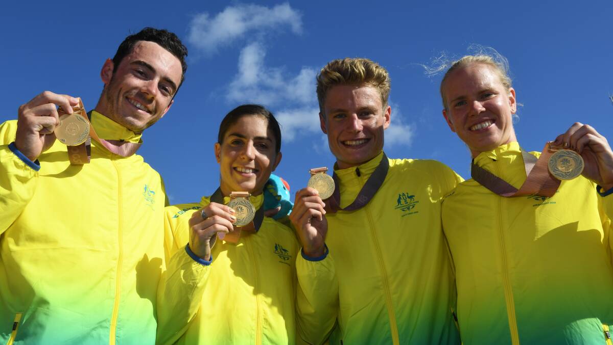 WOO HOO: Gold medalists Jacob Birtwhistle, Ashleigh Gentle, Matthew Hauser and Gillian Backhouse after winning the mixed team relay triathlon on Saturday. Picture: AAP