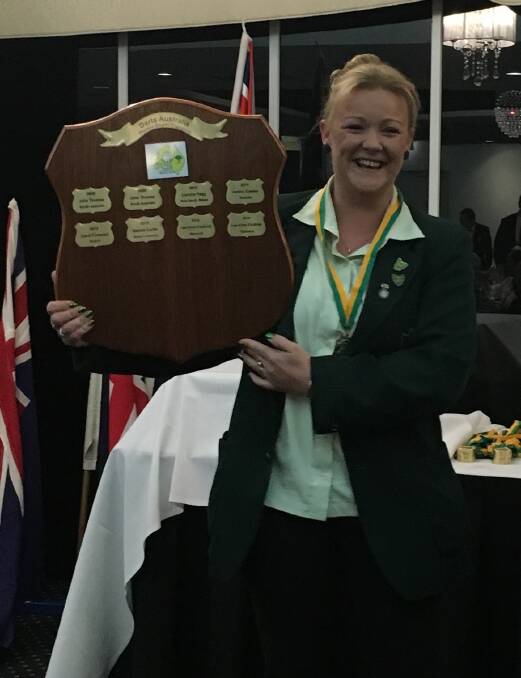 WINNER: Cressy darts player Tereasa Morris with the Australian women's singles darts trophy she won in Melbourne.
