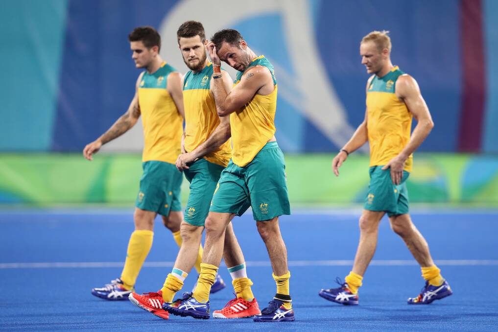 Launceston hockey star Tim Deavin (far right) follows dejected Australian teammates off the field in Rio after defeat in the men's pool A match against Spain. Picture: Getty Images