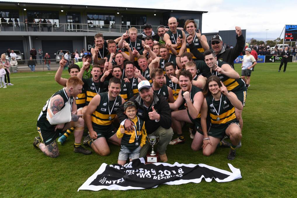 VICTORIOUS: St Pats celebrate their fourth NTFA division 2 reserves premiership in five seasons. Picture: Paul Scambler