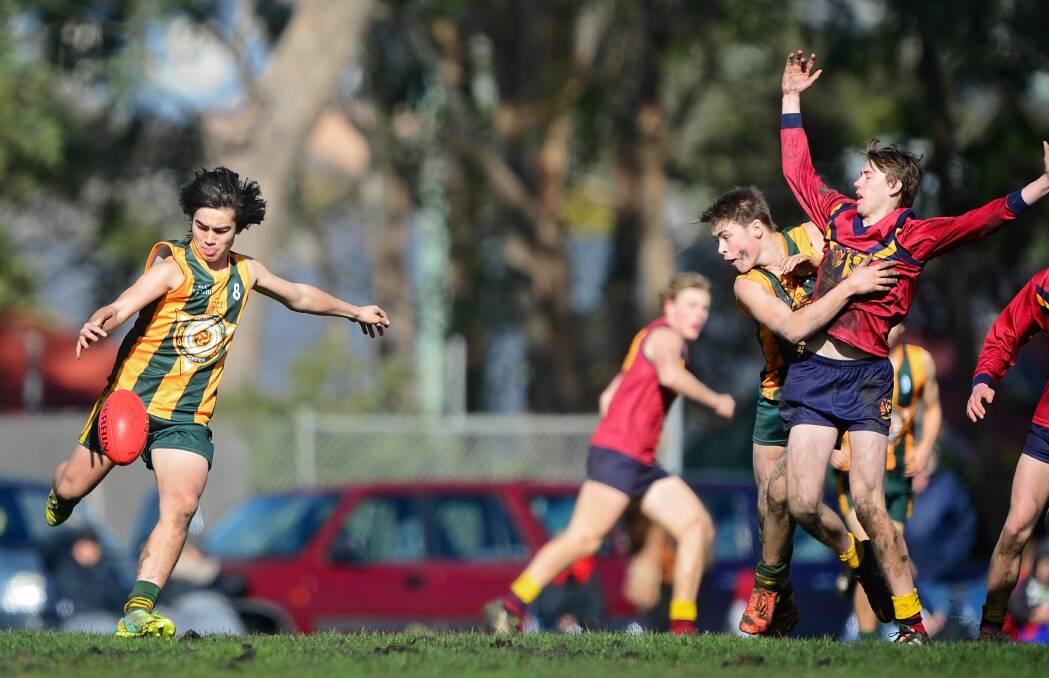 BREAKAWAY: St Pats' Liam Kiely runs into space and kicks downfield during the college's sixth-straight SATIS senior first football grand final victory. Picture: Phillip Biggs