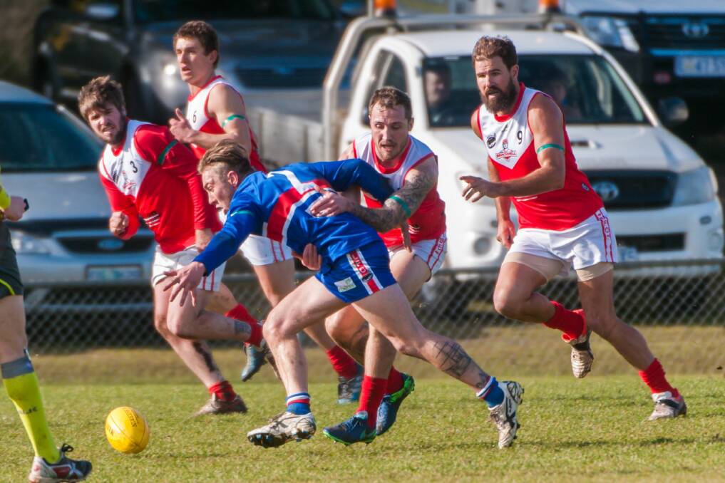 HOWLING DOGS: South Launceston midfielder Jordan Tepper leads Redlegs Jacob Gelston to the ball in the Bulldogs' victory at Youngtown Oval. Picture: Phillip Biggs