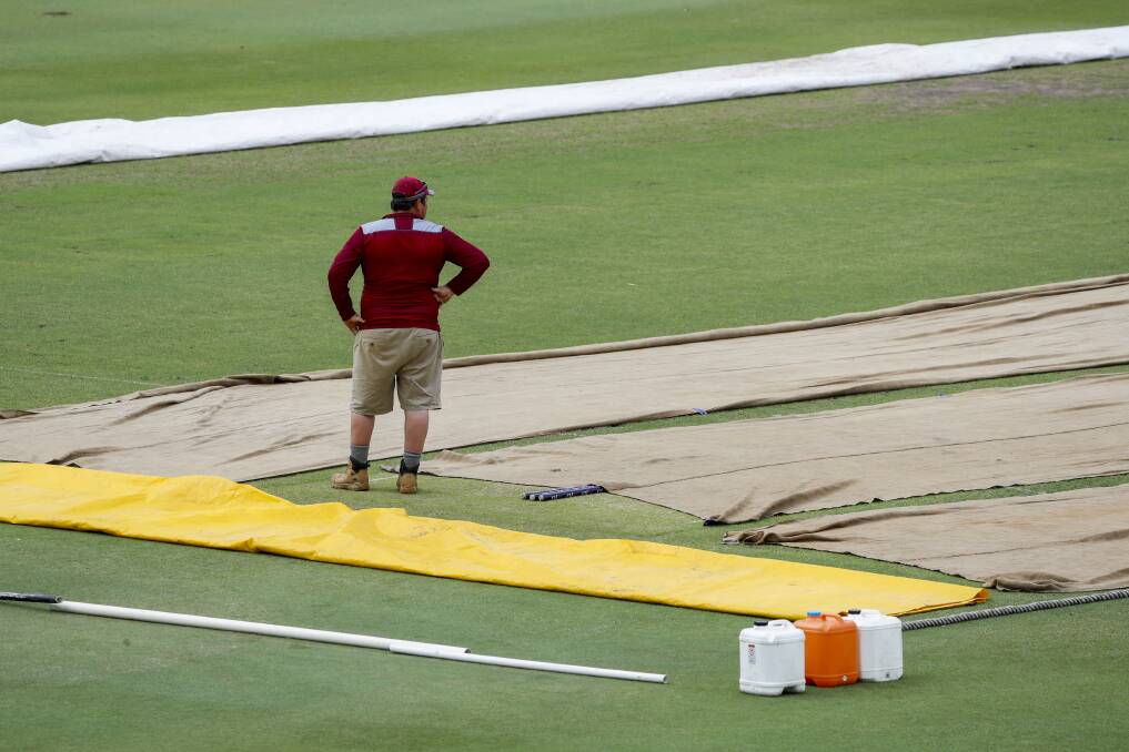TICK TOCK: Rain delays the start of the first session during day one of the Sheffield Shield final between Queensland and Tasmania at the Allan Border Field in Brisbane. Picture: AAP