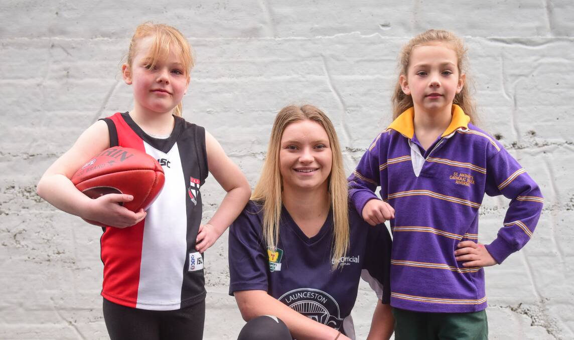NO BOYS ALLOWED: Girls only Auskick Lite participants Olivia Sweeney, 7, and Amaya Maynard-Collier, 8, with Launceston star player Daria Bannister. Picture: Paul Scambler  