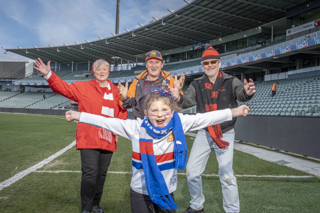 Swans supporter Margret Price, Giants supporter Rick De Sousa, Essendon fan Charlie Andrews and Doggies fan Lily Dusautoy, 8, at UTAS Stadium. Picture: Craig George 