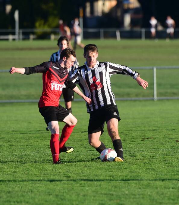 CONTEST: Launceston City's Thomas Frost battles Ulverstone's Timothy Read for possession at Mitsubishi Park on Saturday. Picture: Paul Scambler.