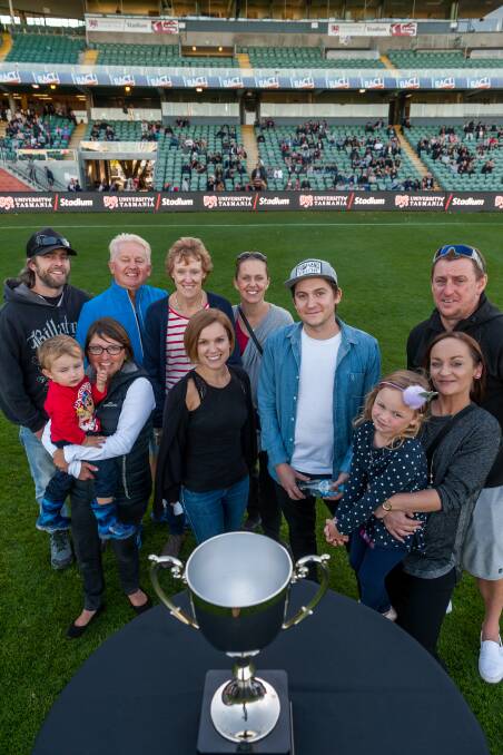 PROUD: Family members of former The Examiner sports journalist Phil Edwards with the cup that bears his name at UTAS Stadium on Good Friday. Picture: Phillip Biggs