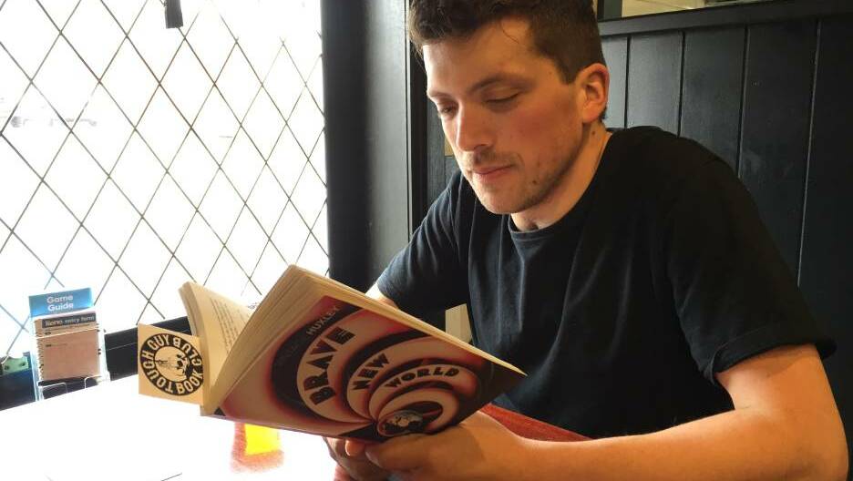  Tough Guy Book Club Launceston president Pod Pickering enjoying a beer while delving into some literary greatness. Picture: Sarah Aquilina