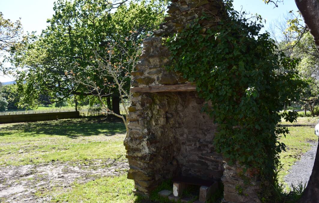 RELICS: An old chimney sits in the yard of "honeymoon cottage". It is believed that this is the original chimney from the home's outdoor kitchen. Pictures: Zona Black