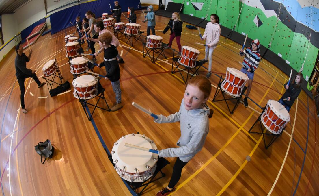 BEAT: Yyan Ng takes the PCYC school holiday taiko drumming class, with Trevallyn's Charlotte McKendry on the front row. Picture: Paul Scambler