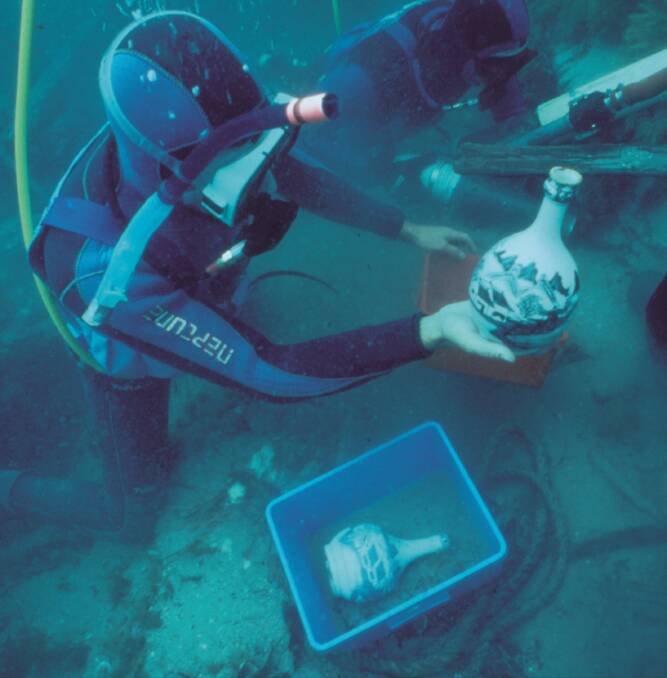 UNCOVERED: A diver with Chinese export porcelain from the Sydney Cove shipwreck. Picture: Tasmanian Parks and Wildlife Service