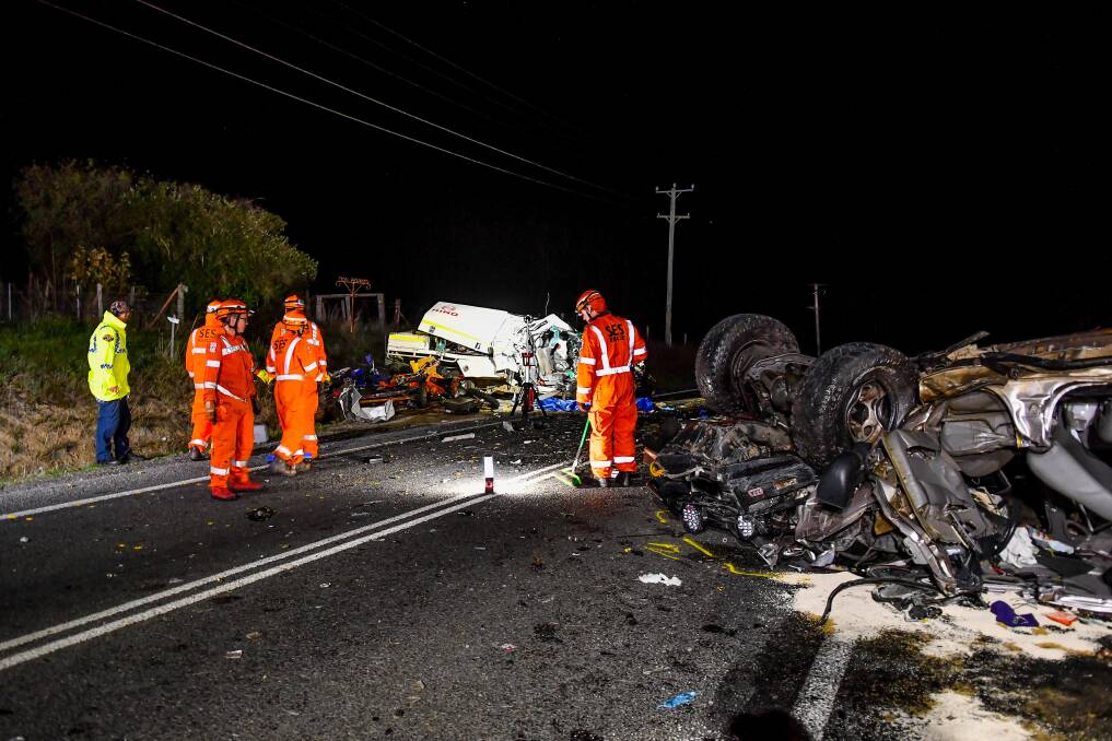 Horrific: Emergency service workers at the scene of a fatal two vehicle crash on the West Tamar Highway at Loira, five kilometres north of Exeter.