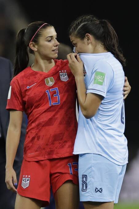 United States' Alex Morgan consoles Thailand's Miranda Nild at the end of the their World Cup match.