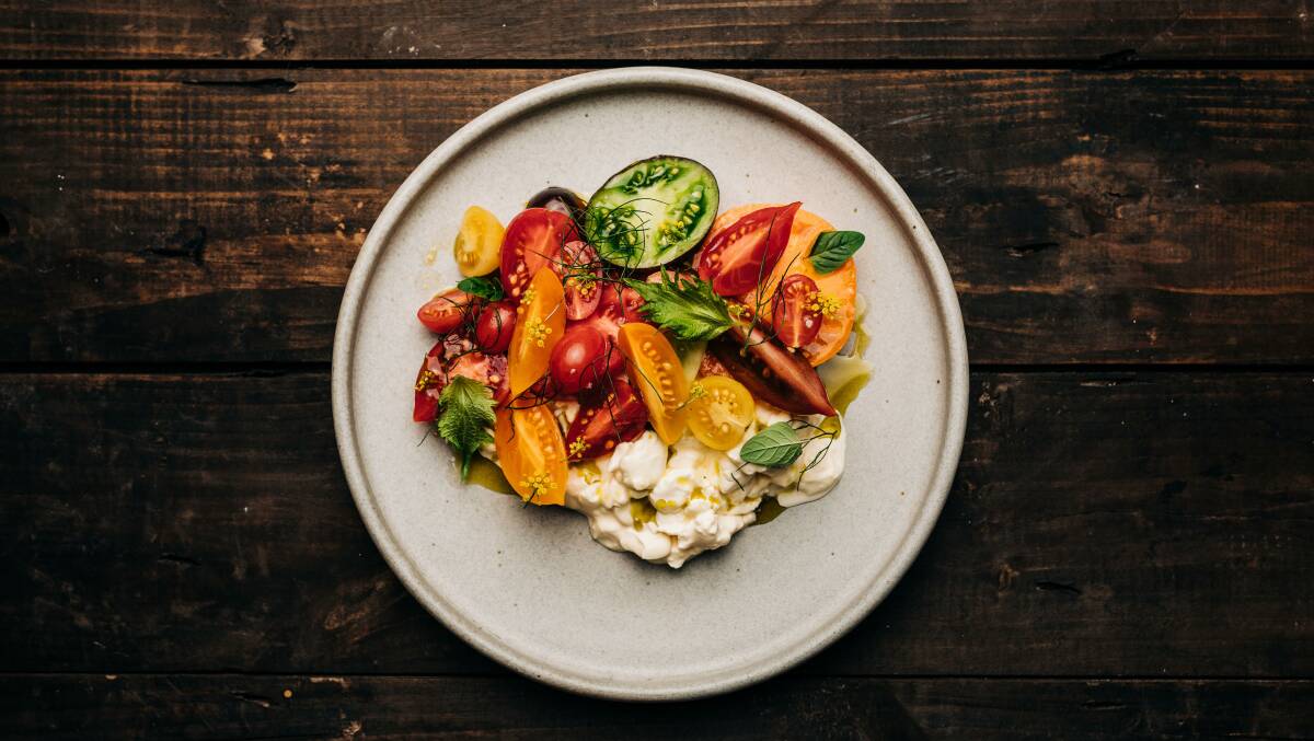 Annettes tomatoes and peaches with honey vinegar and burrata curds. Picture: Adam Gibson