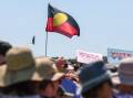 The Aboriginal flag flying at a Yes rally on the mainland. Picture by Adam McLean