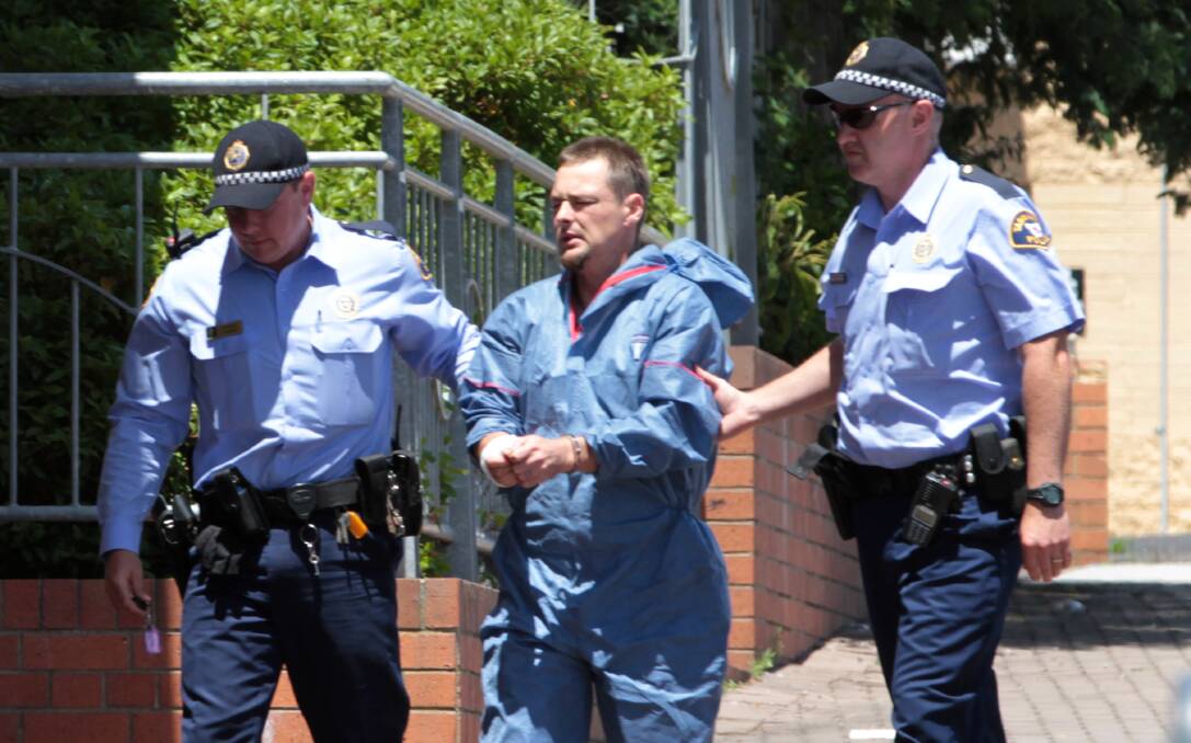 KILLER: Adrian Wayne Smillie is led into court in 2012 following the murder of Benjamin Murray Maxwell. Picture: File
