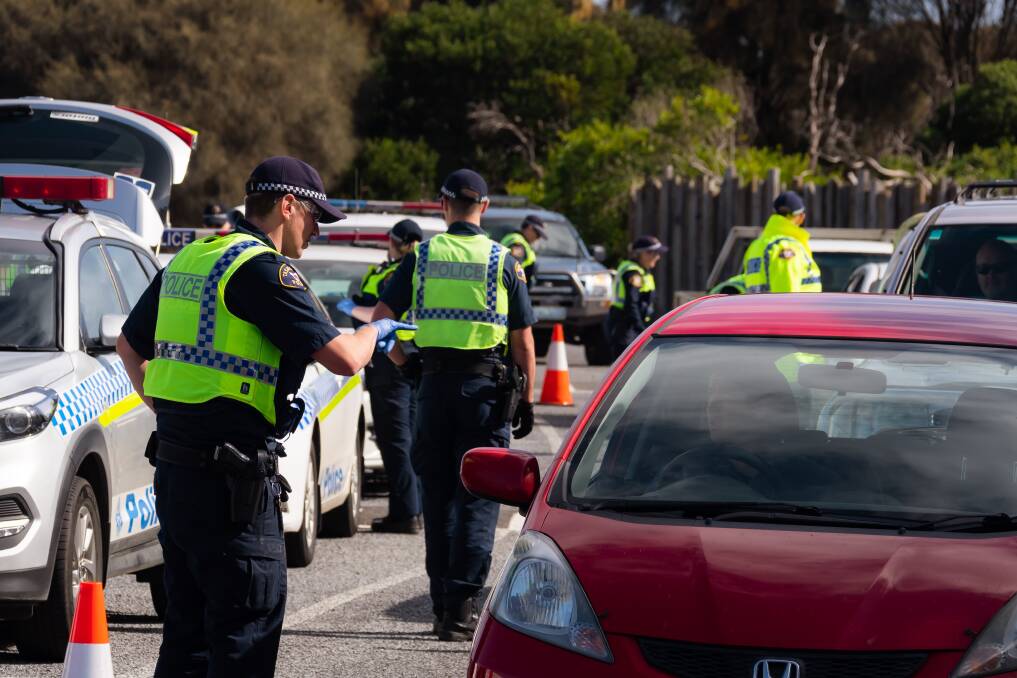 CHECKPOINT: Tasmania Police officers conducting a roadblock stop to ensure drivers' travel was for an essential purpose on the Bass Highway. Picture: Simon Sturzaker 