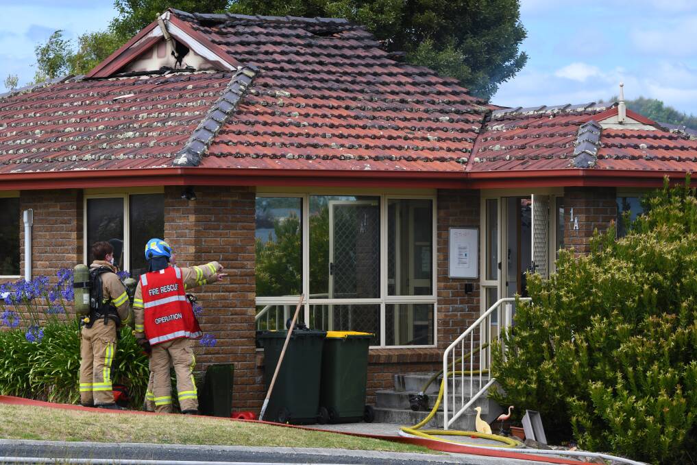 BLAZE: Tasmania Fire Service firefighters investigate the blaze which seriously damaged a unit at Cape Country Accommodation on Thursday. Picture: Brodie Weeding