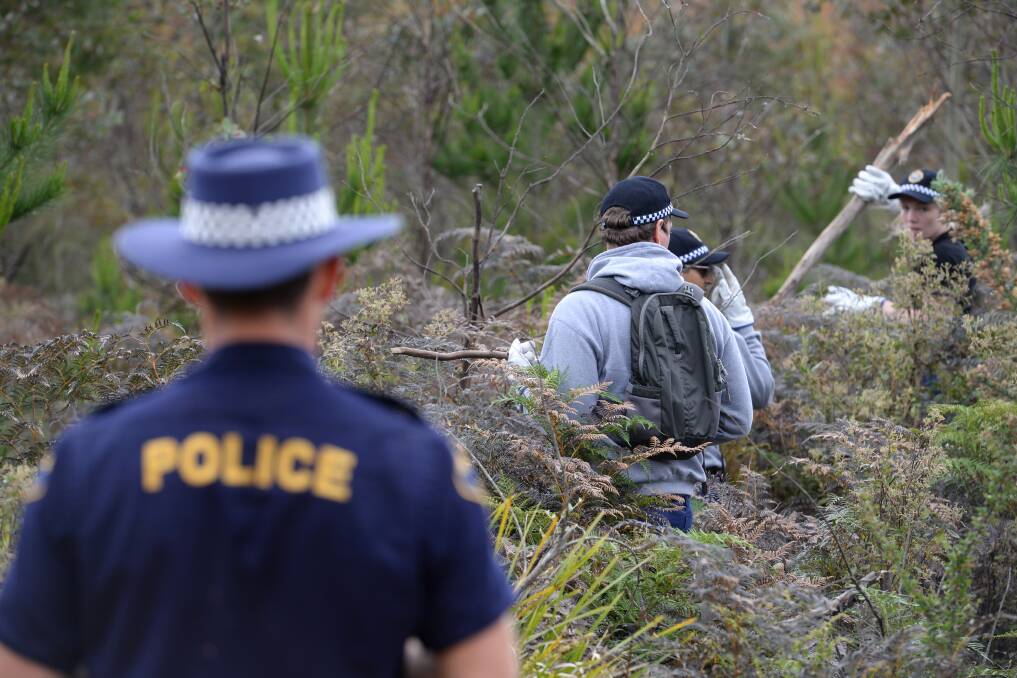 Police, in 2016, search the Dulverton bushland where Noel Ingham's decapitated corpse was found. 